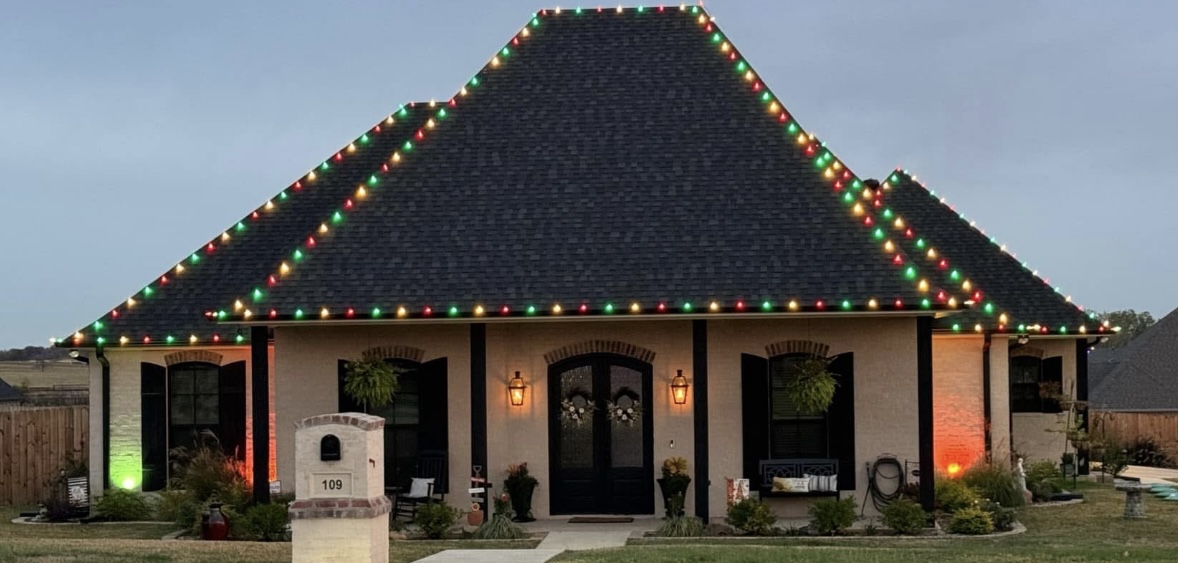 Home with red, green and warm white Christmas lights along the roofline