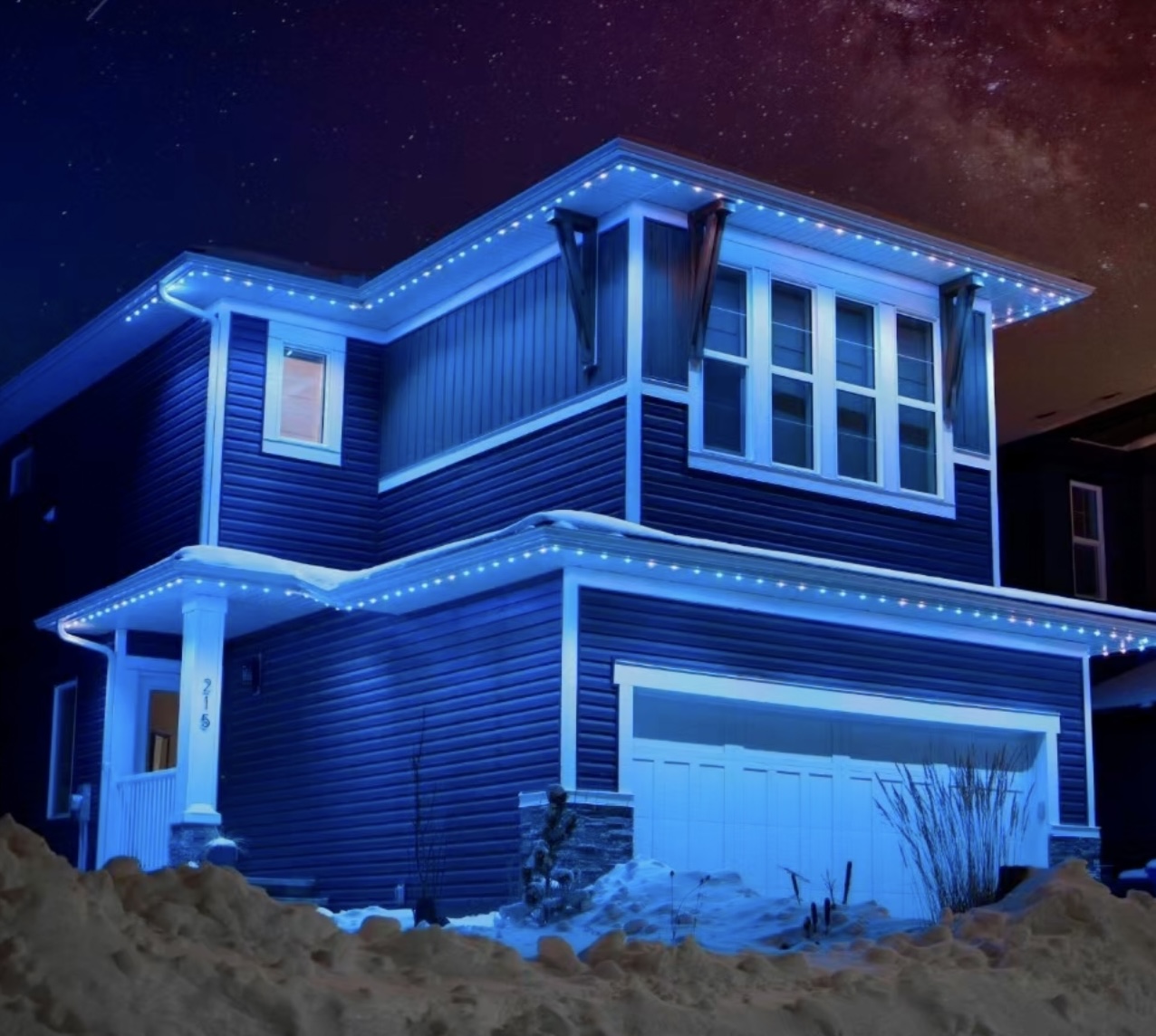 Blue-lit home with holiday roofline lights under a starry sky